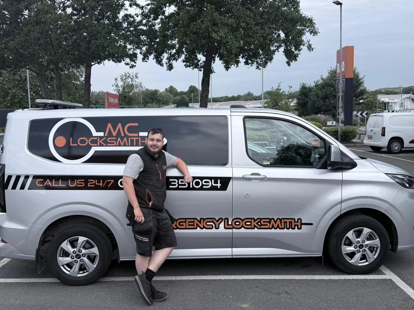 Morgan Cornelius standing beside his MCLocksmiths van